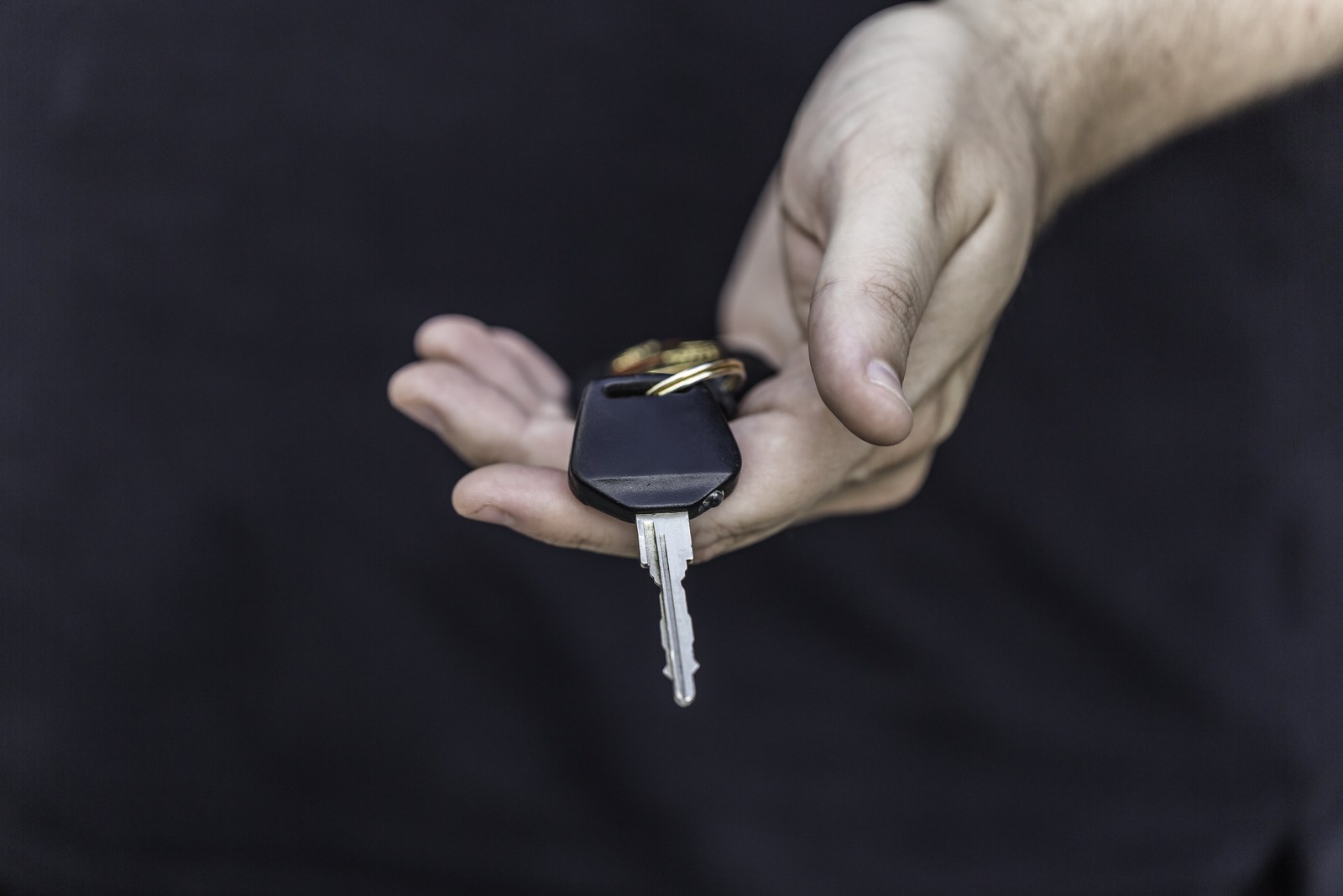 Driver holding car keys while reviewing owner and non-owner coverage